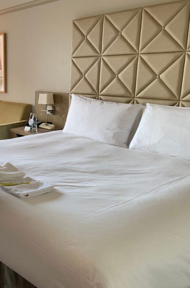 The Deluxe King room at Hilton Tokyo Odaiba — a large bed with a tufted headboard