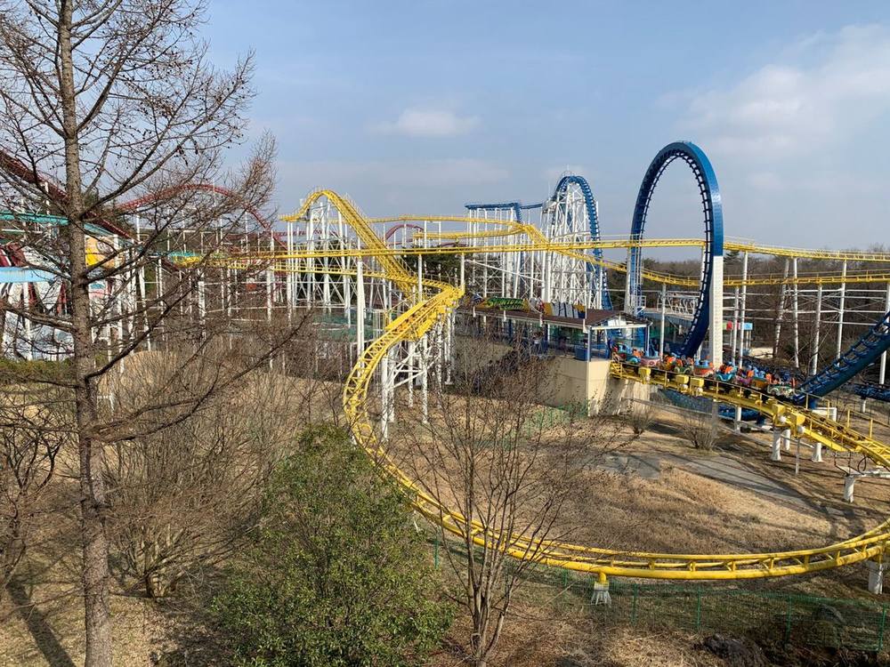 A roller coaster track weaving through the forest at Nasu Highland Park